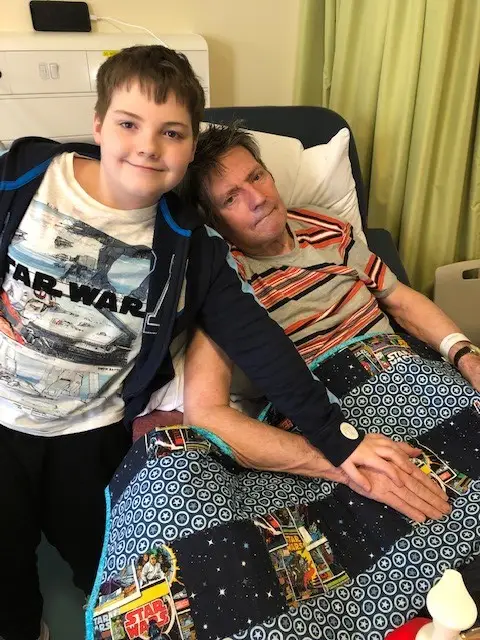 Alan and grandson Charlie with Charlie's Star Wars quilt at the hospice