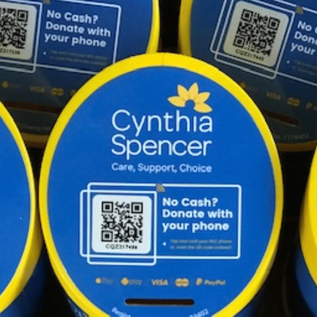 Cynthia Spencer collection boxes with a QR code for donating by phone
