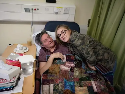 Abbi and Alan with Abbi's vintage quilt at the hospice