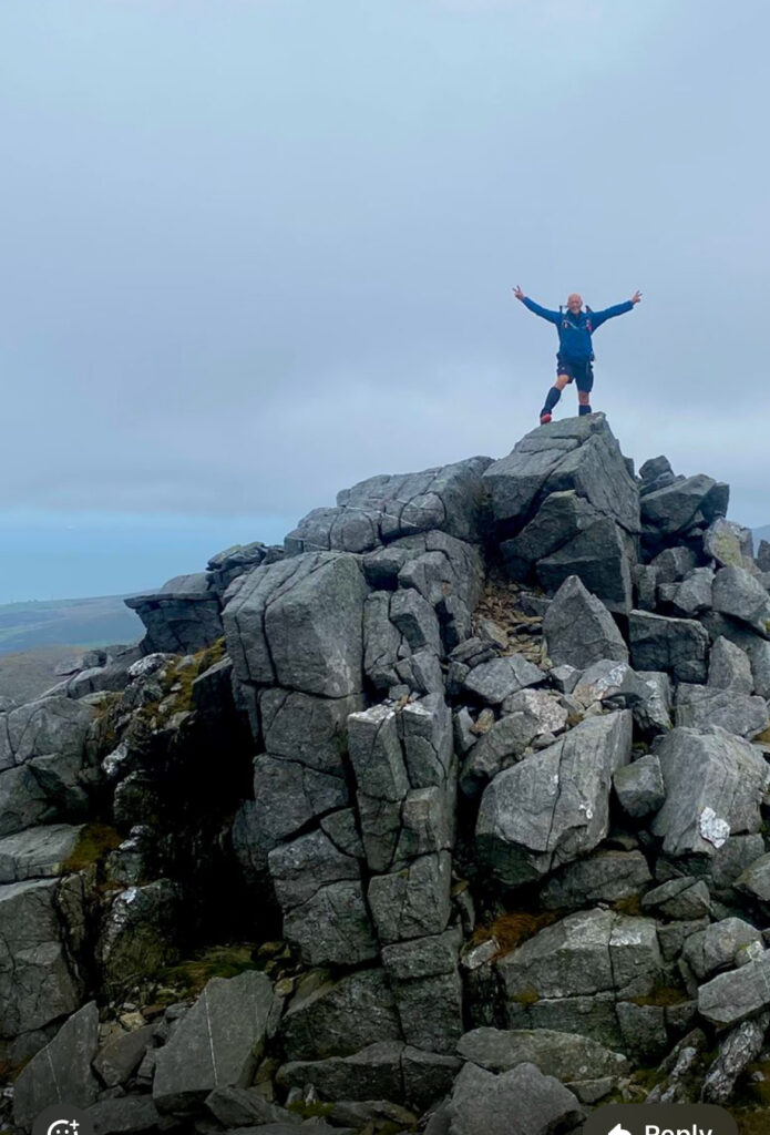 Man on top of a mountain.